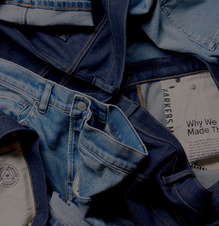A pile of NZ blue jeans in various denim shades, some showing pockets and inner labels.