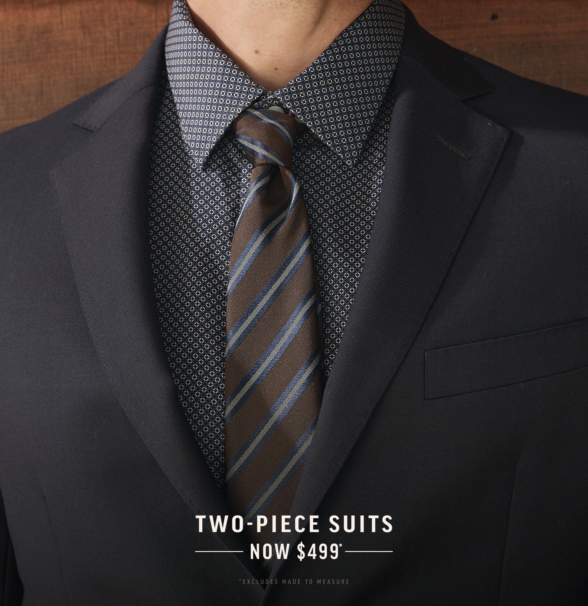 NZ man in a dark suit and patterned shirt with striped tie; Two-Piece Suits Now $499* text.