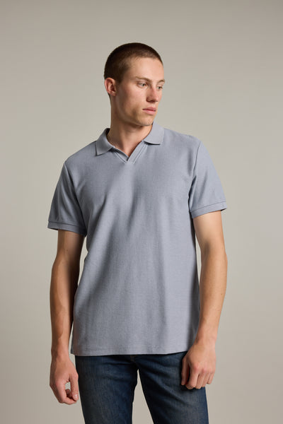 Man in a Barkers Winfield Textured Polo, made with responsibly sourced cotton, looking left.