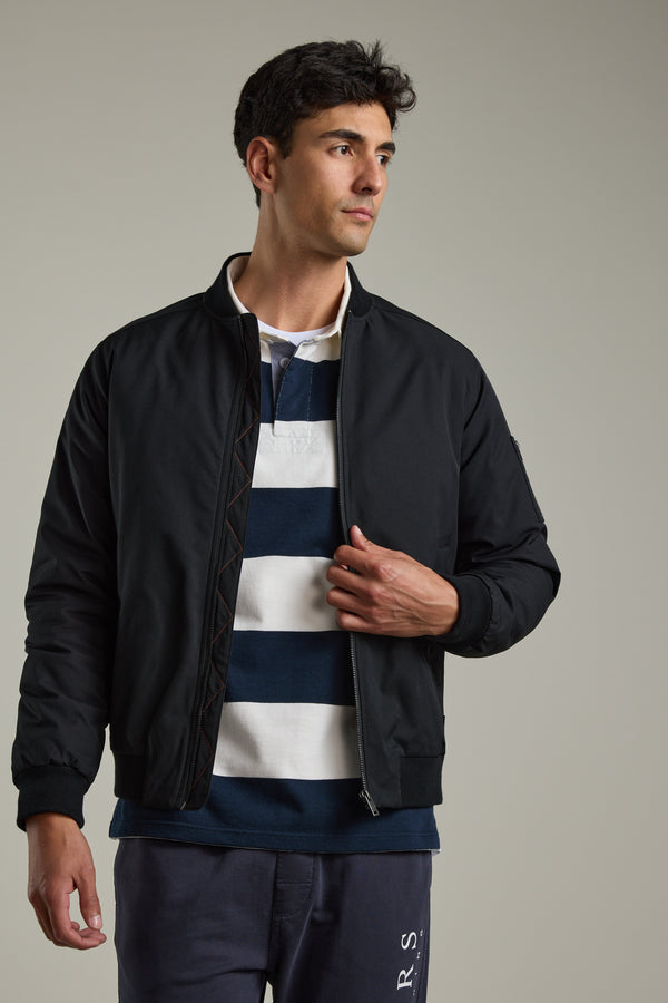 Man in Barkers Provincial Long Sleeve Rugby Jersey and black jacket looking to the side.