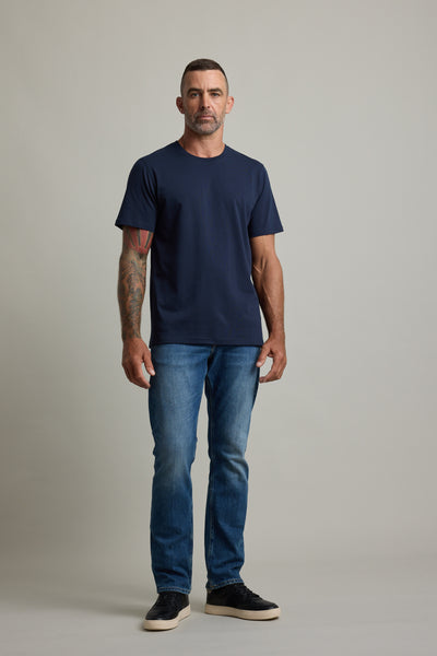 Man with short hair in a Barkers Good Earth Cotton Essential Tee poses confidently.