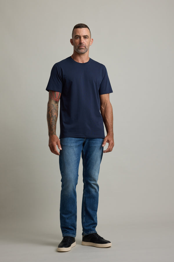 Man with short hair in a Barkers Good Earth Cotton Essential Tee poses confidently.