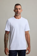 Man with short hair, tattooed arm, in Barkers Good Earth Cotton Essential Tee, standing.