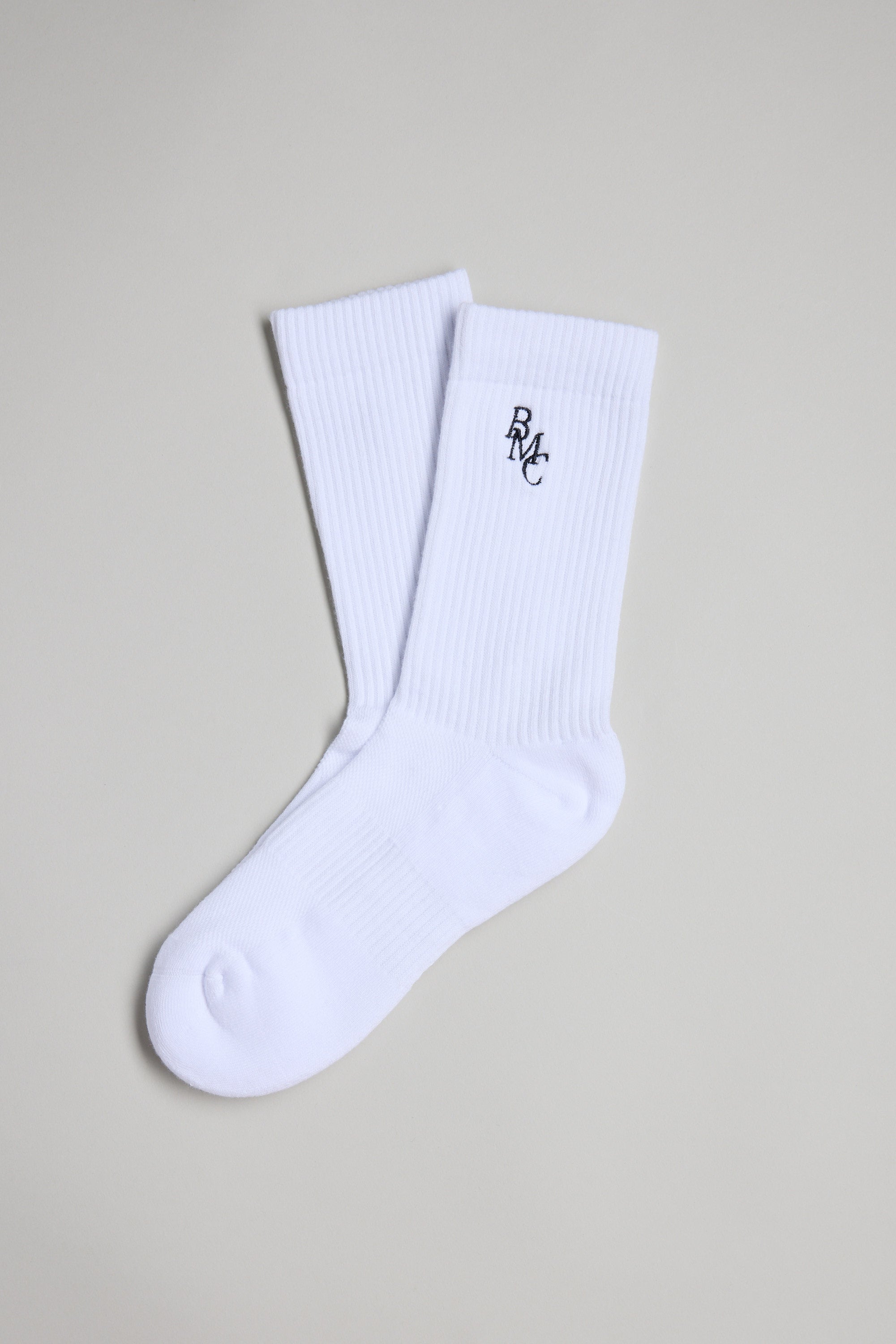 The Barkers BMC Ribbed Sock is a white crew sock featuring a small black BMC logo embroidered near the top, shown against a light gray background.