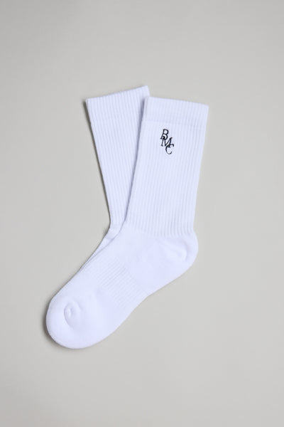 The Barkers BMC Ribbed Sock is a white crew sock with ribbed cuffs and a small black BMC logo embroidered near the top, shown on a plain light gray background.