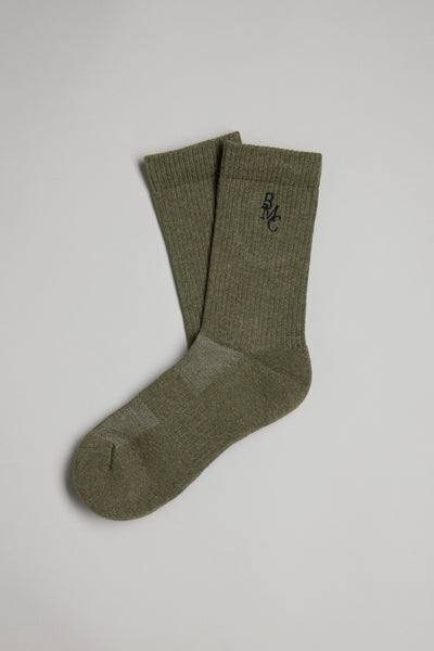 The BMC Ribbed Sock by Barkers is an olive green crew sock featuring a small black embroidered logo near the top, shown laid flat on a light gray background.