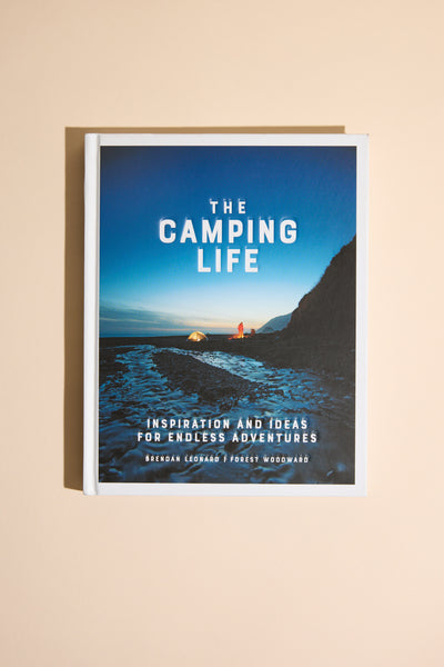 Camping Life by Other features a cover photo of a glowing tent on a rocky New Zealand beach at dusk, with ocean and cliffs in the background. Tagline: Inspiration and Ideas for Endless Outdoor Adventure.