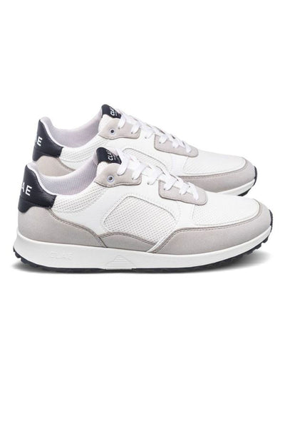 The Clae Joshua sneakers by Clae feature a low-top design in white and light gray with black heel and sole accents, mesh and suede details made from recycled materials, and white laces.