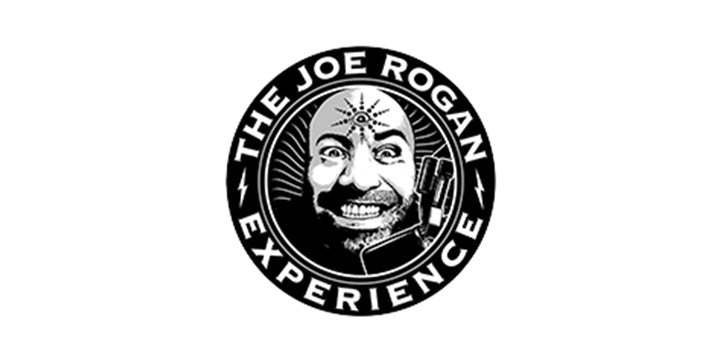 Black and white circular logo for The Joe Rogan Experience podcast featuring a grinning man’s face with a third eye on his forehead, a microphone, and bold text around the edge.