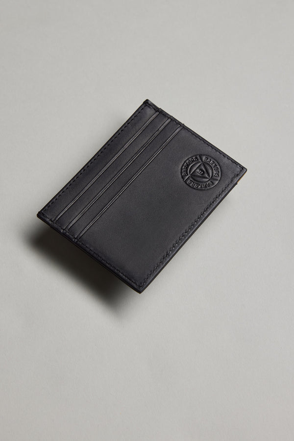 The Barkers Taylor Leather Card Wallet, made from black leather with three slots and an embossed circular logo in the top right corner, is displayed on a light grey surface.